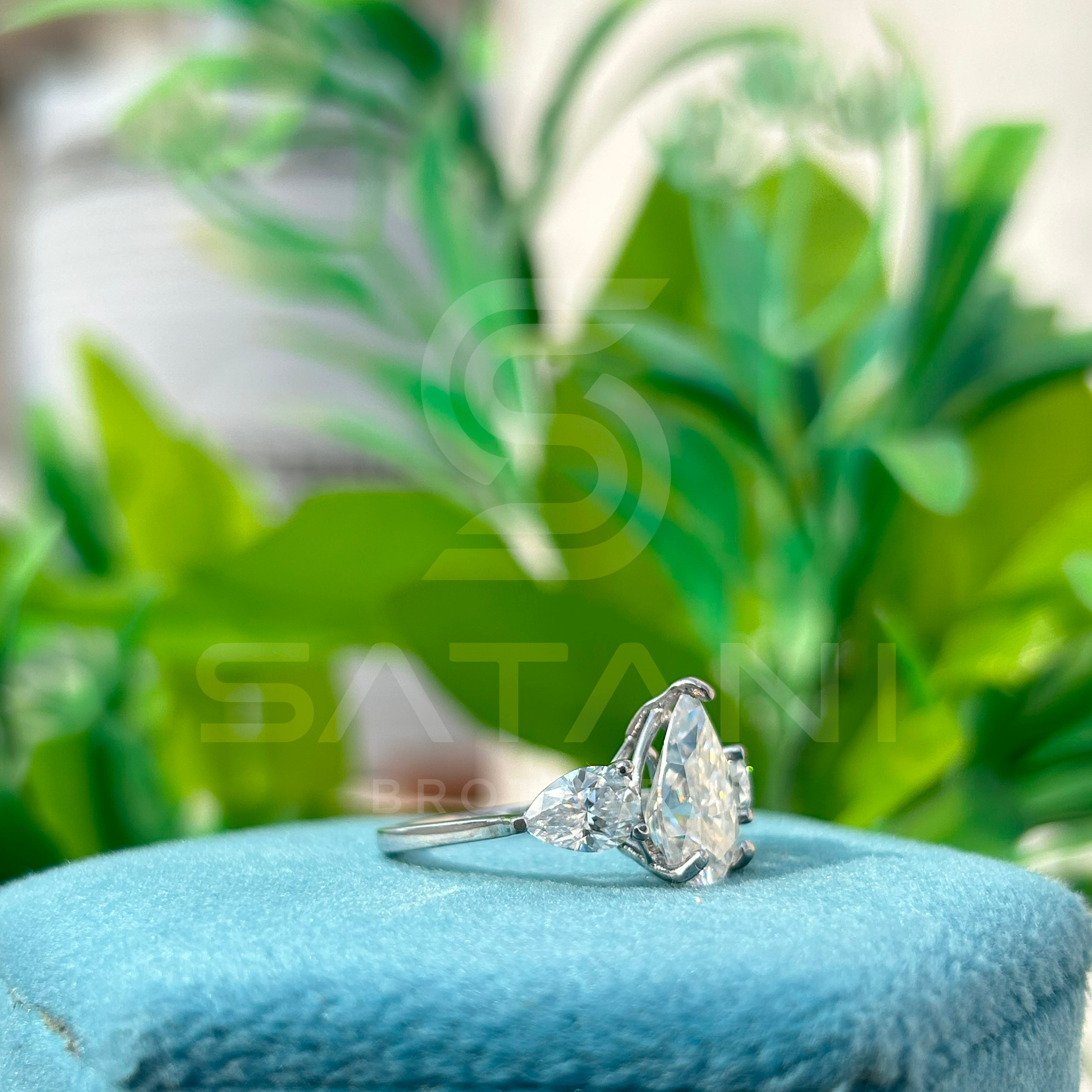 “Pear Shape Diamond Three Stone Engagement Ring with Oval Side Stones”