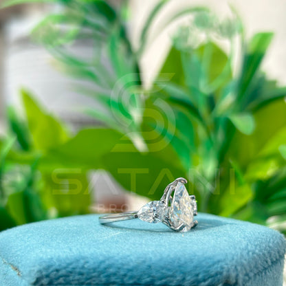 “Pear Shape Diamond Three Stone Engagement Ring with Oval Side Stones”