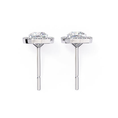 Pair of silver earrings with clear gemstones on a white background